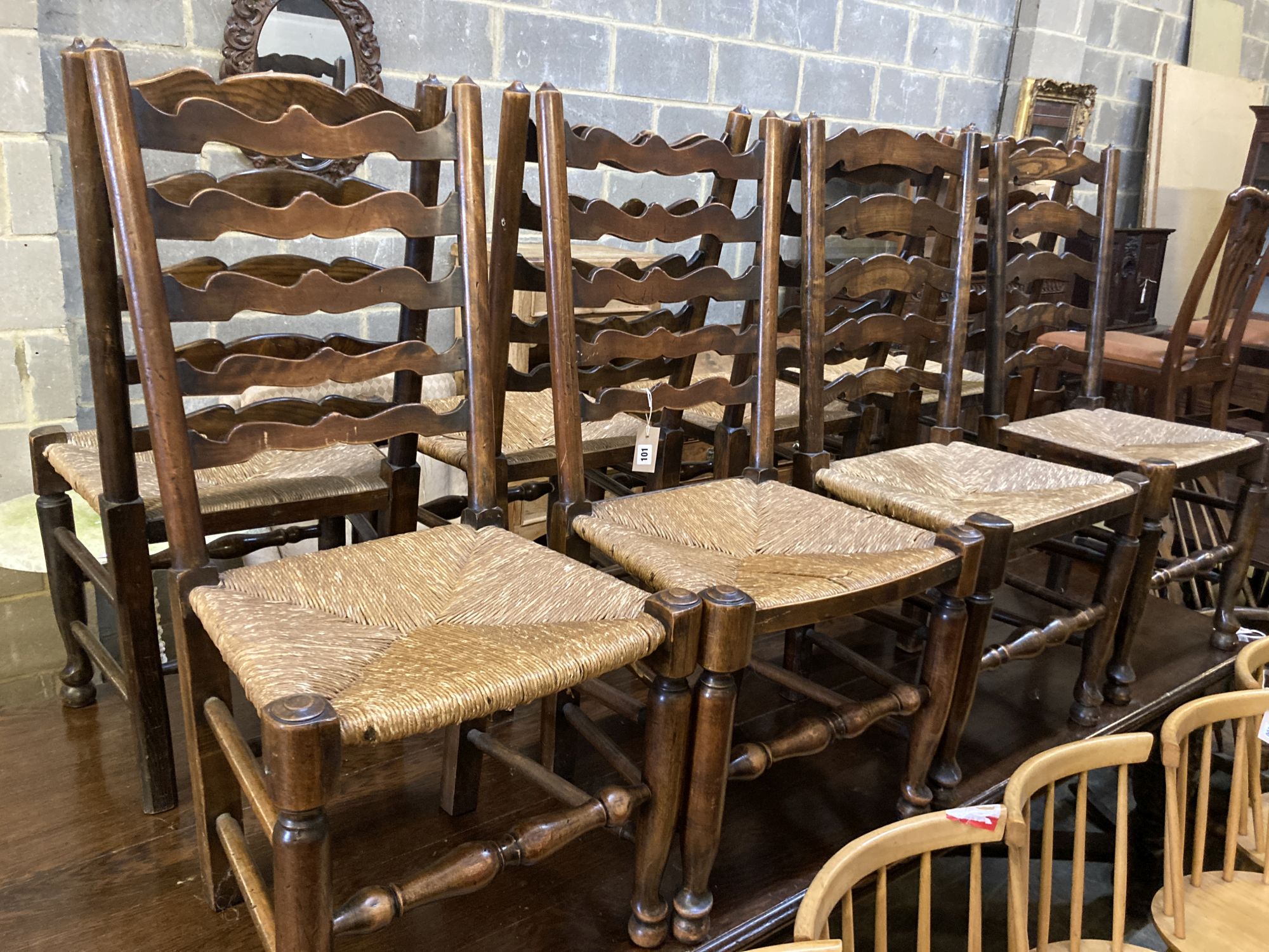 A harlequin set of nine early 19th century ash rush seated ladderback dining chairs (5 and 4)
